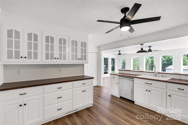 5323 Flat Creek Rd, Heath Springs, SC 29058 - kitchen featuring dishwasher, a textured ceiling, dark wood finished floors, glass insert cabinets, and wooden counters