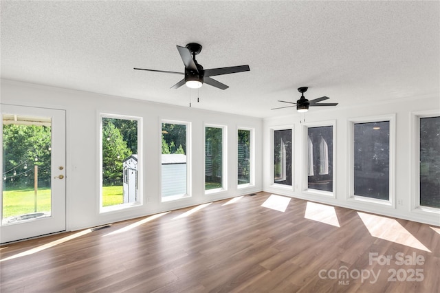 5323 Flat Creek Rd, Heath Springs, SC 29058 - unfurnished sunroom featuring a textured ceiling and wood finished floors