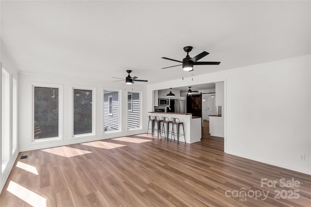 5323 Flat Creek Rd, Heath Springs, SC 29058 - living room featuring a ceiling fan, wood finished floors, and crown molding