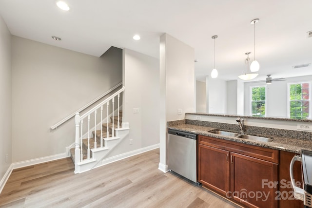 1126 Dean Hall Ln, Matthews, NC 28105 - kitchen featuring dishwasher, a sink, light wood-style floors, dark stone countertops, and decorative light fixtures