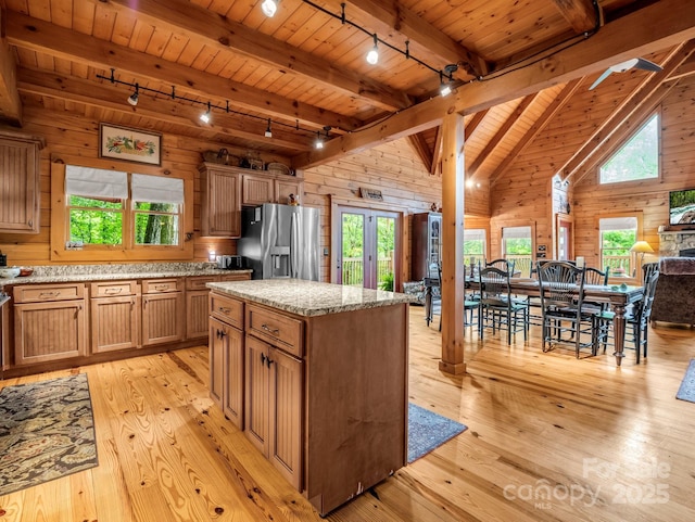 120 Rocky Mountain Dr, Lake Lure, NC 28746 - kitchen with rail lighting, stainless steel fridge with ice dispenser, a wooden ceiling with exposed beams, wooden walls, and light wood-style floors