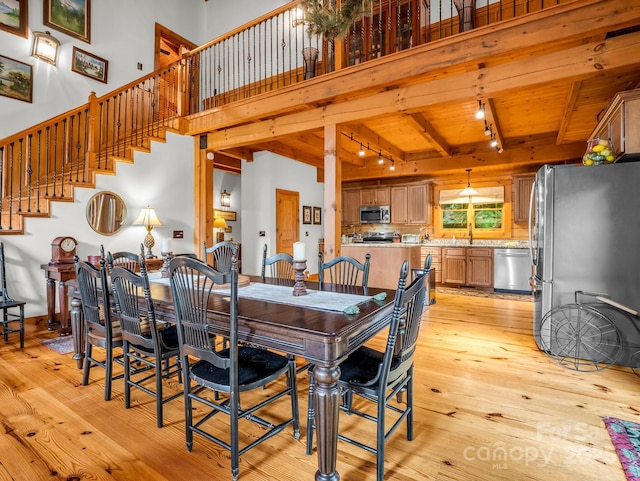 120 Rocky Mountain Dr, Lake Lure, NC 28746 - dining space featuring rail lighting, light wood-type flooring, a towering ceiling, a wooden ceiling with exposed beams, and stairway