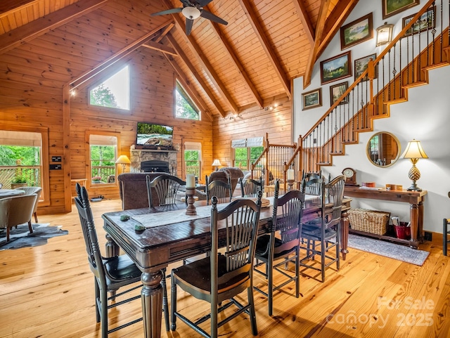 120 Rocky Mountain Dr, Lake Lure, NC 28746 - dining space featuring high vaulted ceiling, a wooden ceiling with exposed beams, a stone fireplace, stairs, and light wood-type flooring
