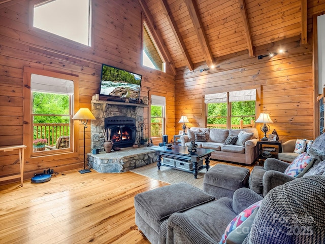 120 Rocky Mountain Dr, Lake Lure, NC 28746 - living area with plenty of natural light, hardwood / wood-style floors, a fireplace, wooden walls, and a wooden ceiling with exposed beams