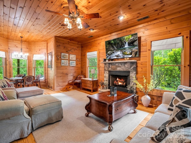 120 Rocky Mountain Dr, Lake Lure, NC 28746 - living room with wood ceiling, a ceiling fan, a chandelier, a stone fireplace, and wood walls