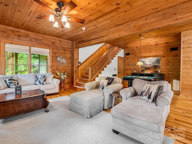 120 Rocky Mountain Dr, Lake Lure, NC 28746 - living room with wood walls, stairway, wood finished floors, pool table, and ceiling fan