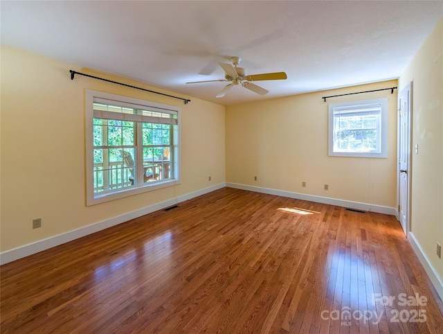 355 Rosewood Ln, Burnsville, NC 28714 - empty room featuring plenty of natural light, wood-type flooring, a ceiling fan, and baseboards