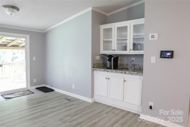 1184 Sherwood Rd, Clover, SC 29710 - bar area featuring light wood-style floors, a textured ceiling, ornamental molding, and baseboards