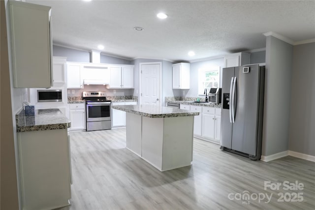 1184 Sherwood Rd, Clover, SC 29710 - kitchen featuring appliances with stainless steel finishes, crown molding, light wood-style floors, a kitchen island, and recessed lighting