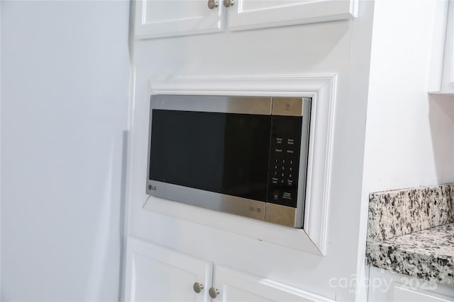 1184 Sherwood Rd, Clover, SC 29710 - kitchen view of stainless steel microwave, white cabinets, and light countertops