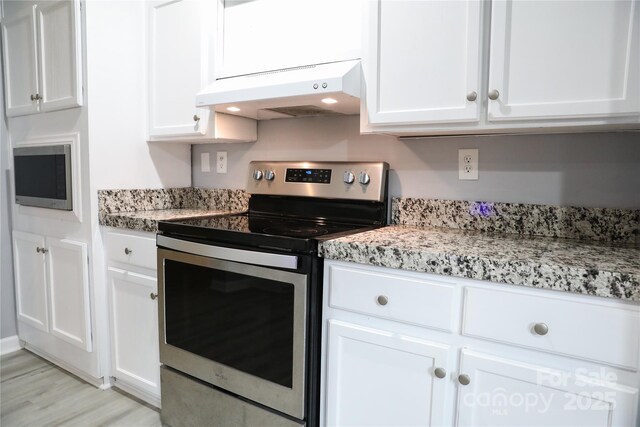 1184 Sherwood Rd, Clover, SC 29710 - kitchen featuring stainless steel appliances, under cabinet range hood, white cabinets, and light wood finished floors