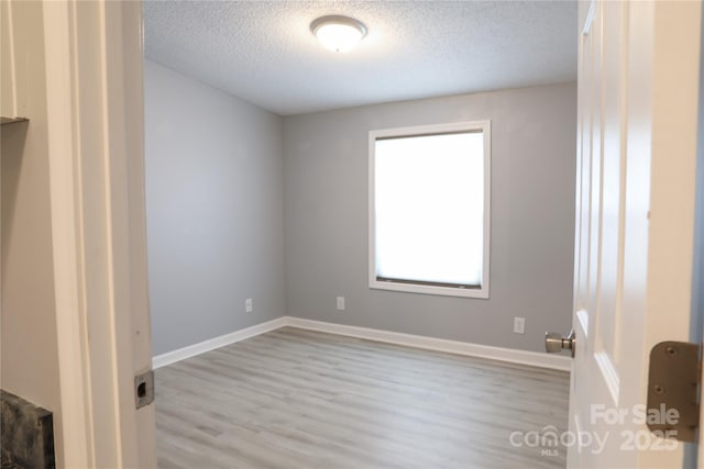 1184 Sherwood Rd, Clover, SC 29710 - spare room featuring wood finished floors, a textured ceiling, and baseboards