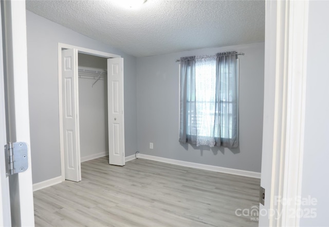 1184 Sherwood Rd, Clover, SC 29710 - unfurnished bedroom with light wood-type flooring, a textured ceiling, a closet, and baseboards