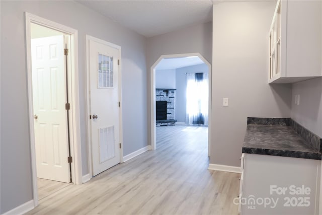 1184 Sherwood Rd, Clover, SC 29710 - hallway featuring arched walkways, light wood finished floors, and baseboards