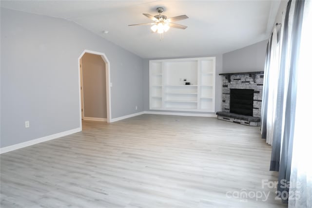 1184 Sherwood Rd, Clover, SC 29710 - unfurnished living room with light wood-style floors, a ceiling fan, baseboards, built in shelves, and vaulted ceiling