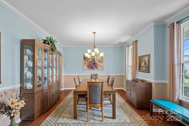 7339 Millstone Cir SW, Concord, NC 28025 - dining room with wood finished floors, a chandelier, crown molding, and baseboards