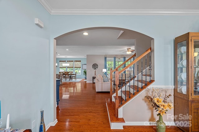 7339 Millstone Cir SW, Concord, NC 28025 - foyer entrance with ceiling fan, arched walkways, wood finished floors, baseboards, and ornamental molding