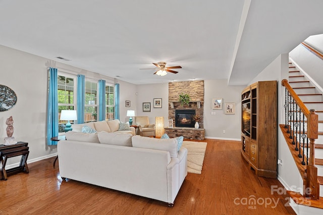 7339 Millstone Cir SW, Concord, NC 28025 - living area featuring a ceiling fan, stairway, wood finished floors, a fireplace, and baseboards