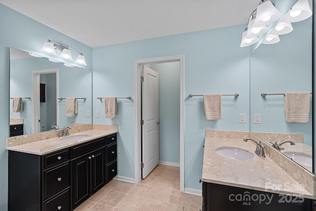 7339 Millstone Cir SW, Concord, NC 28025 - full bathroom with two vanities, baseboards, and tile patterned flooring