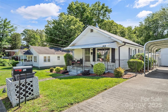 302 N St, Morganton, NC 28655 - view of front of house featuring a front yard, a porch, a detached carport, and driveway