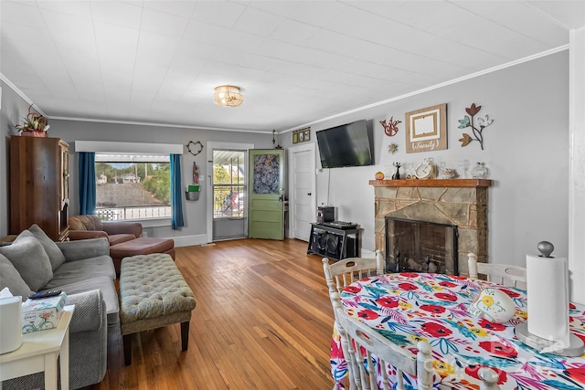 302 N St, Morganton, NC 28655 - living room featuring crown molding, hardwood / wood-style flooring, a stone fireplace, and baseboards