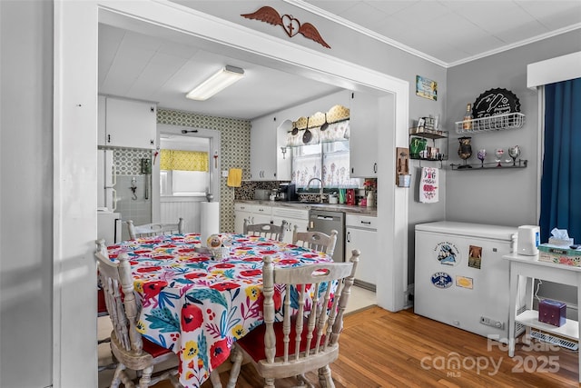 302 N St, Morganton, NC 28655 - dining space with light wood finished floors and crown molding