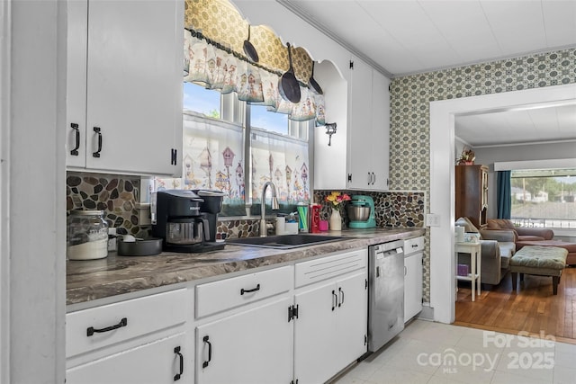 302 N St, Morganton, NC 28655 - kitchen featuring a sink, dishwasher, crown molding, white cabinets, and light tile patterned flooring