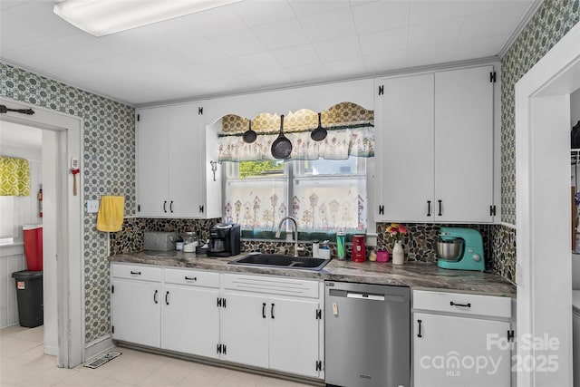 302 N St, Morganton, NC 28655 - kitchen featuring stainless steel dishwasher, wallpapered walls, a sink, white cabinetry, and decorative backsplash