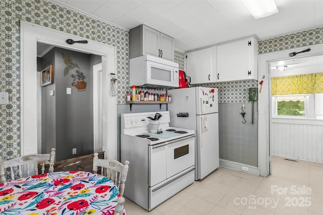 302 N St, Morganton, NC 28655 - kitchen with white appliances, wallpapered walls, and light tile patterned flooring