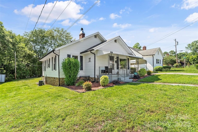 302 N St, Morganton, NC 28655 - view of front of home with a chimney, covered porch, a front yard, and cooling unit