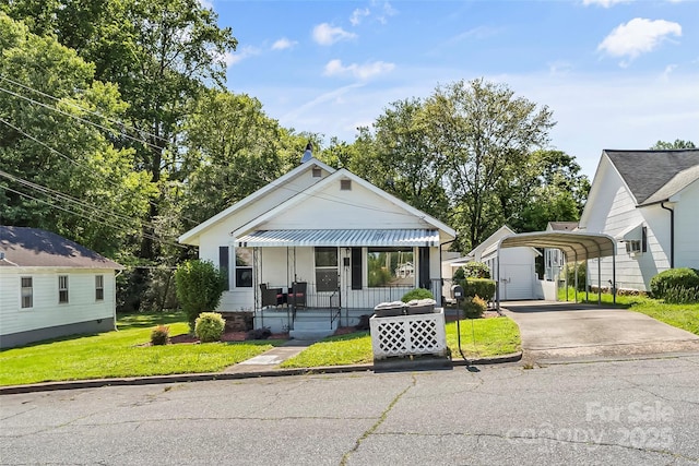 302 N St, Morganton, NC 28655 - bungalow-style house with a carport, driveway, a front lawn, and covered porch