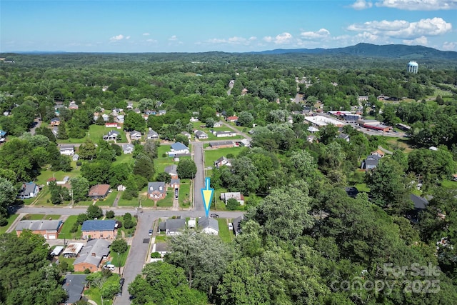 302 N St, Morganton, NC 28655 - aerial overview of property's location with a heavily wooded area and a mountainous background