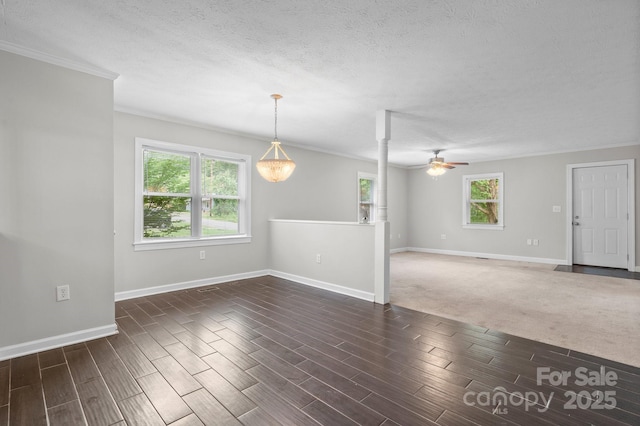 352 18th Ave NE, Hickory, NC 28601 - unfurnished living room with ceiling fan, baseboards, crown molding, wood finished floors, and a textured ceiling