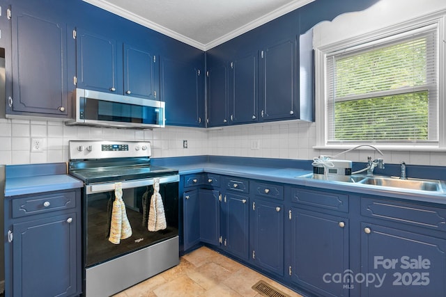 352 18th Ave NE, Hickory, NC 28601 - kitchen with appliances with stainless steel finishes, blue cabinetry, backsplash, and crown molding