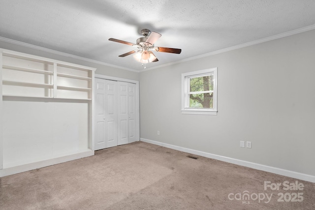 352 18th Ave NE, Hickory, NC 28601 - unfurnished bedroom with crown molding, carpet floors, baseboards, ceiling fan, and a closet