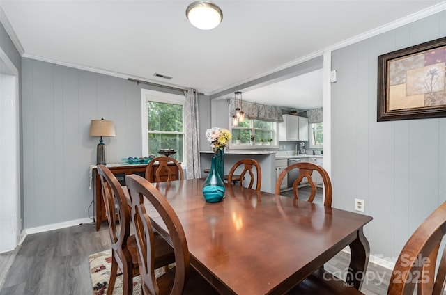 12504 Culp Rd, Gold Hill, NC 28071 - dining space featuring dark wood-style floors, a decorative wall, and crown molding