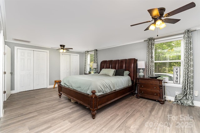 12504 Culp Rd, Gold Hill, NC 28071 - bedroom featuring light wood-style flooring, two closets, and ceiling fan