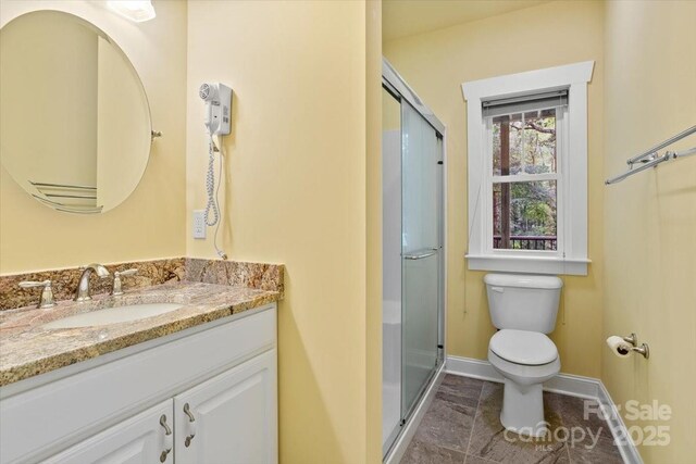 311 Carriage Crest Dr, Hendersonville, NC 28791 - full bathroom with toilet, vanity, a shower stall, and baseboards
