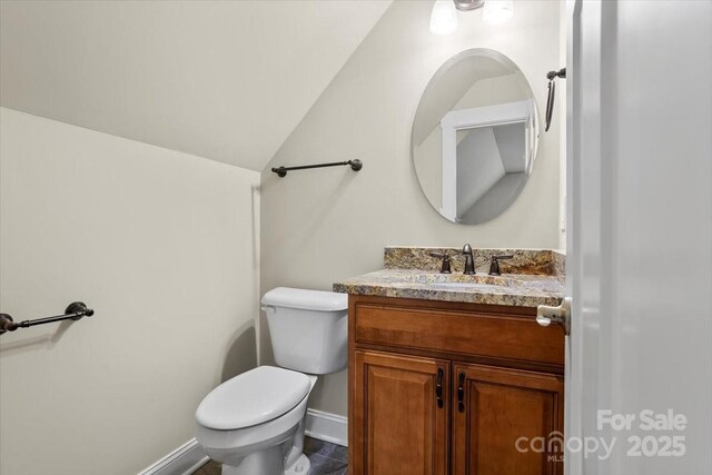 311 Carriage Crest Dr, Hendersonville, NC 28791 - half bath with toilet, vanity, baseboards, and vaulted ceiling