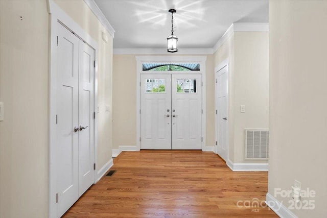 311 Carriage Crest Dr, Hendersonville, NC 28791 - entryway with crown molding and light wood-type flooring