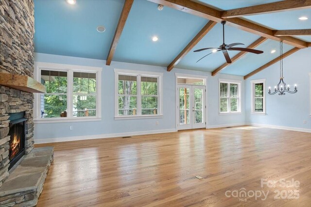 311 Carriage Crest Dr, Hendersonville, NC 28791 - unfurnished living room featuring a stone fireplace, plenty of natural light, ceiling fan, baseboards, and beamed ceiling