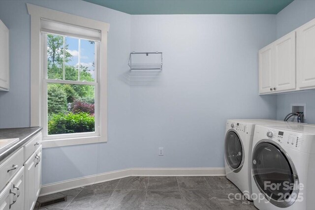 311 Carriage Crest Dr, Hendersonville, NC 28791 - washroom featuring cabinet space, washer and clothes dryer, and baseboards