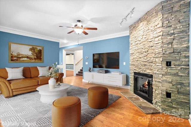 311 Carriage Crest Dr, Hendersonville, NC 28791 - living room with ceiling fan, stairs, a fireplace, wood finished floors, and crown molding