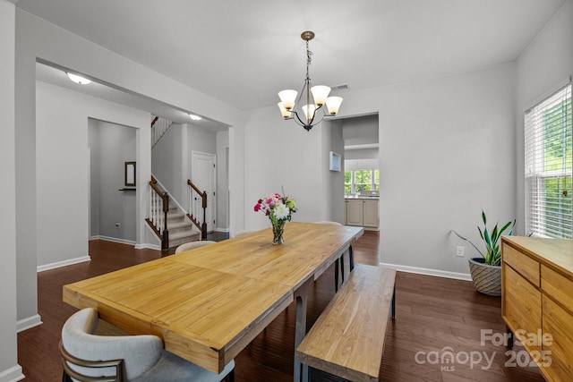 1300 Yellow Springs Dr, Indian Land, SC 29707 - dining space featuring a chandelier, stairway, dark wood-style floors, and plenty of natural light