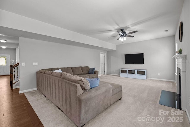 1300 Yellow Springs Dr, Indian Land, SC 29707 - living room featuring baseboards, a ceiling fan, a fireplace, light wood-style flooring, and stairs