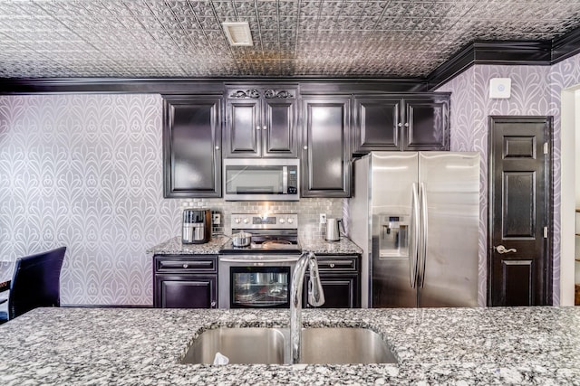 11714 Harsworth Ln, Charlotte, NC 28277 - kitchen with stainless steel appliances, ornamental molding, a sink, an ornate ceiling, and light stone countertops