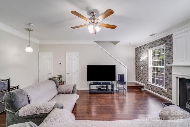 11714 Harsworth Ln, Charlotte, NC 28277 - living room featuring dark wood finished floors, crown molding, ceiling fan, a glass covered fireplace, and baseboards