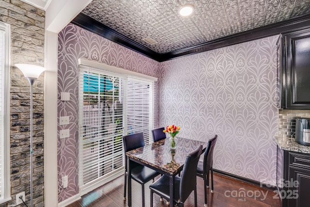 11714 Harsworth Ln, Charlotte, NC 28277 - dining space with wallpapered walls, ornamental molding, dark wood-style floors, and an ornate ceiling