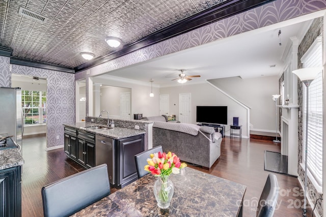 11714 Harsworth Ln, Charlotte, NC 28277 - dining room featuring crown molding, baseboards, dark wood finished floors, a ceiling fan, and an ornate ceiling