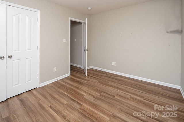 8432 Spirea Ct, Charlotte, NC 28215 - unfurnished bedroom featuring baseboards and wood finished floors
